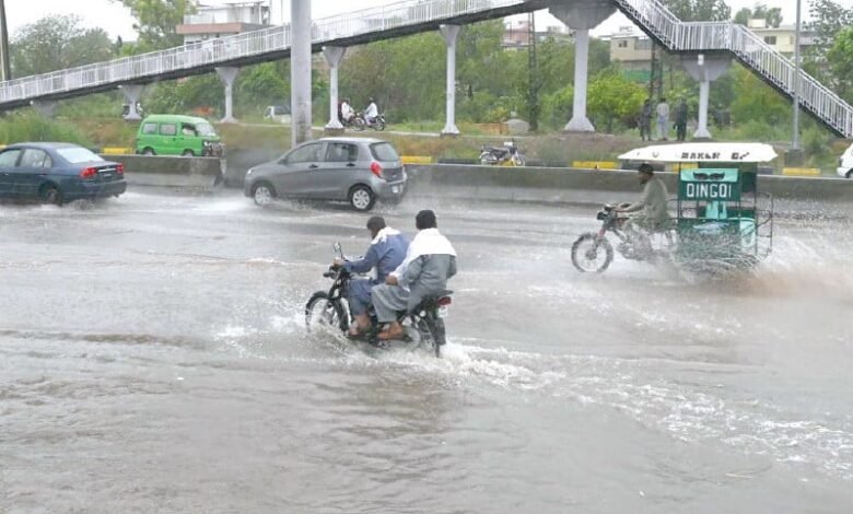 motorists drive through rainwater accumulated on ijp road after a heavy downpour in the federal capital on wednesday photo app